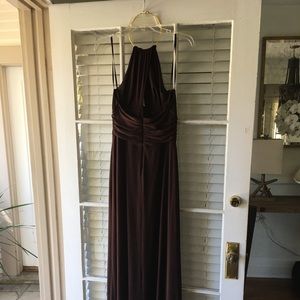 Long brown gown with gold necklace